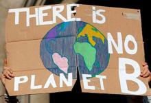 Climate protester holding up picture of the world 