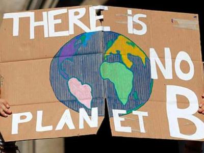 Climate protester holding up picture of the world 